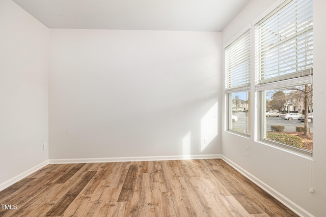 unfurnished room with light hardwood / wood-style floors