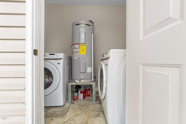 clothes washing area with washer / dryer and water heater