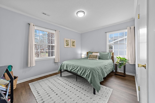 bedroom featuring hardwood / wood-style flooring, crown molding, and a textured ceiling