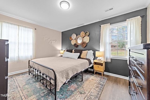 bedroom featuring hardwood / wood-style flooring and ornamental molding