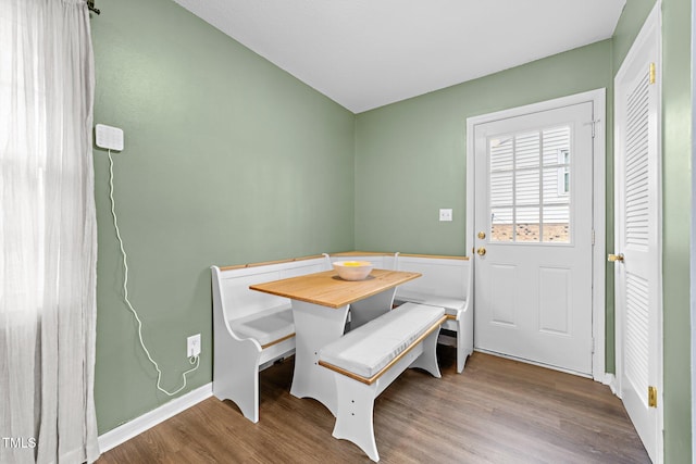 dining room featuring breakfast area and hardwood / wood-style flooring