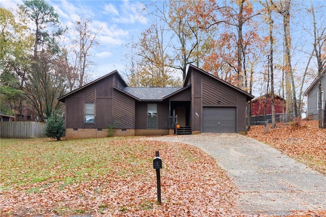 ranch-style home with a garage and a front lawn