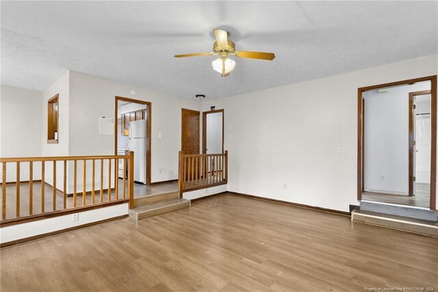 unfurnished room featuring light wood-type flooring and ceiling fan