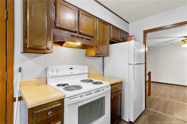 kitchen with ceiling fan, dark hardwood / wood-style flooring, white appliances, and a textured ceiling