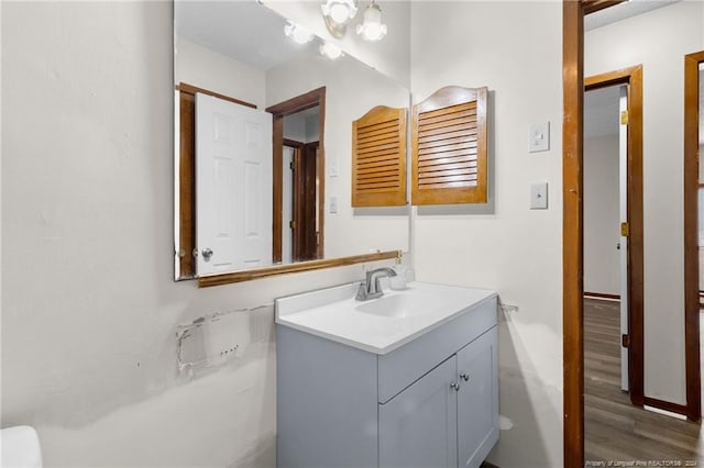 bathroom featuring hardwood / wood-style flooring, vanity, and a chandelier