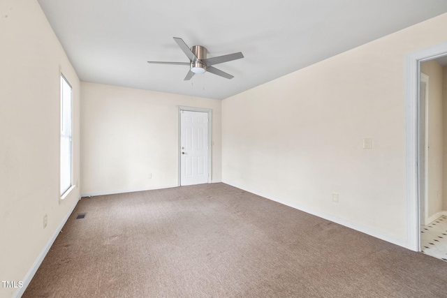 spare room with carpet floors and ceiling fan