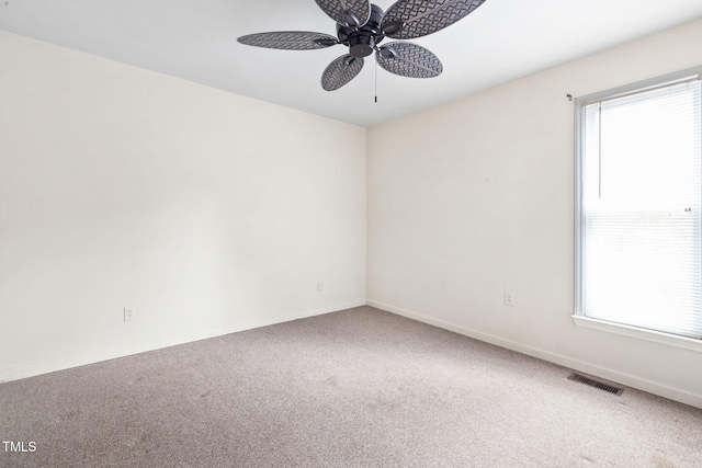 empty room featuring carpet flooring and ceiling fan