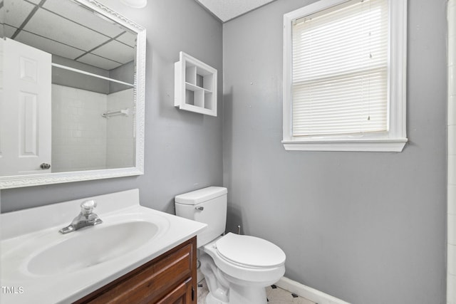 bathroom with vanity, toilet, and a paneled ceiling