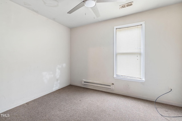 carpeted spare room with ceiling fan and a baseboard radiator