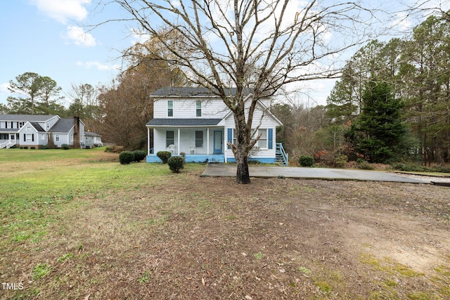 front of property featuring covered porch and a front lawn