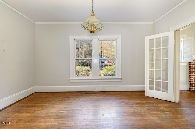 unfurnished dining area with a chandelier, hardwood / wood-style floors, and crown molding