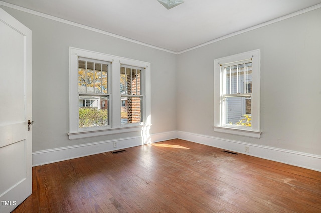 unfurnished room with wood-type flooring and ornamental molding