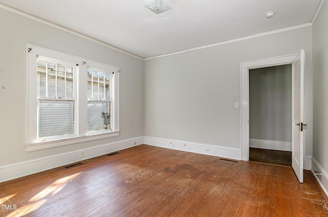 unfurnished room with crown molding and dark wood-type flooring