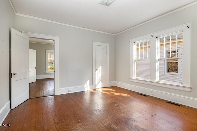 unfurnished room featuring wood-type flooring and ornamental molding