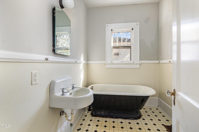 bathroom with a washtub and sink