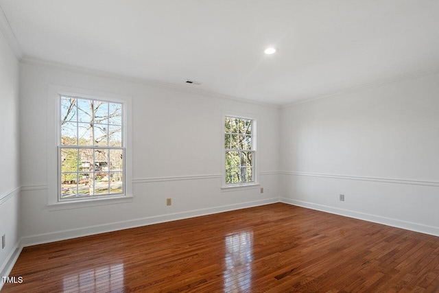 spare room with a healthy amount of sunlight and dark wood-type flooring