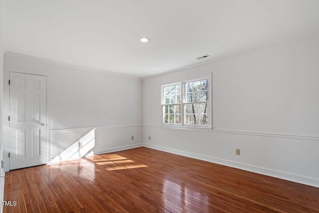 unfurnished room featuring hardwood / wood-style floors and ornamental molding