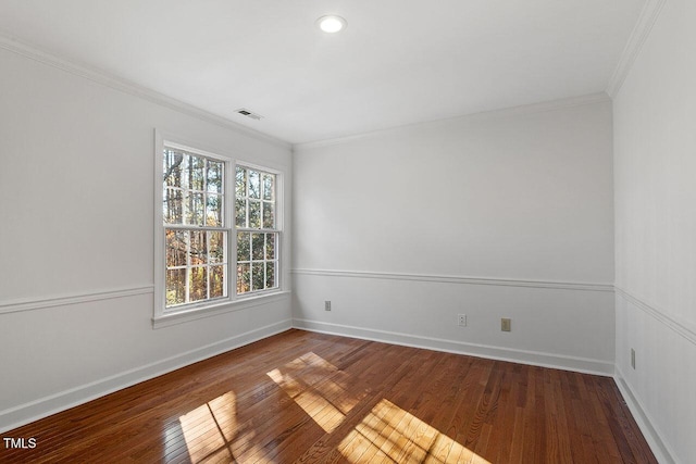 spare room featuring hardwood / wood-style floors and crown molding