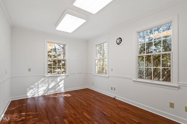 spare room with crown molding and wood-type flooring