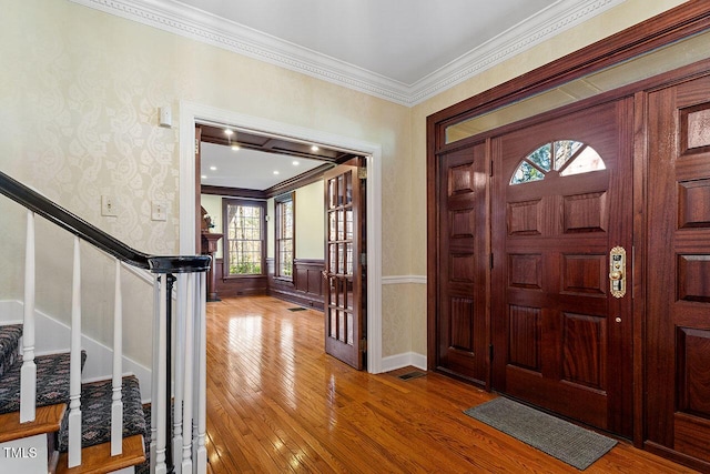 foyer featuring french doors, ornamental molding, and hardwood / wood-style flooring