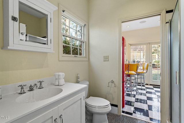 bathroom featuring plenty of natural light, toilet, and vanity