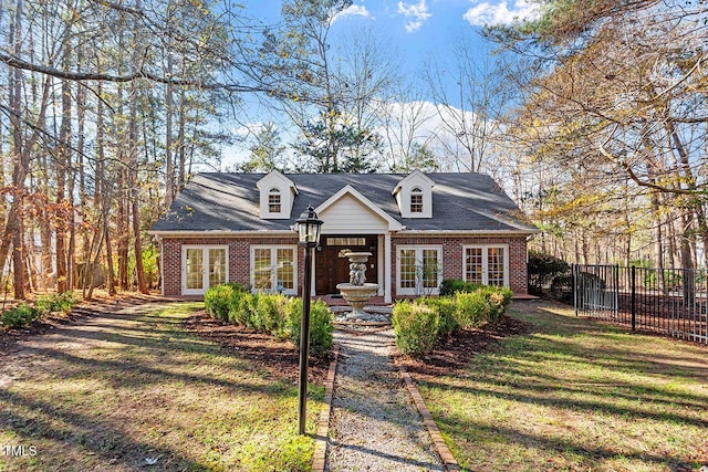 view of front of home with a front lawn and french doors