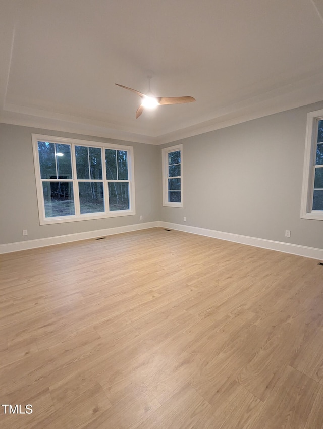 unfurnished room with light wood-type flooring and ceiling fan