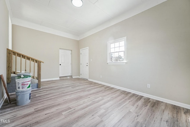 entrance foyer with light hardwood / wood-style floors and ornamental molding