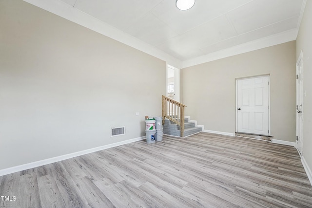 unfurnished room featuring crown molding and light hardwood / wood-style floors