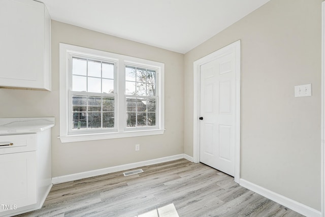 unfurnished dining area with light hardwood / wood-style flooring