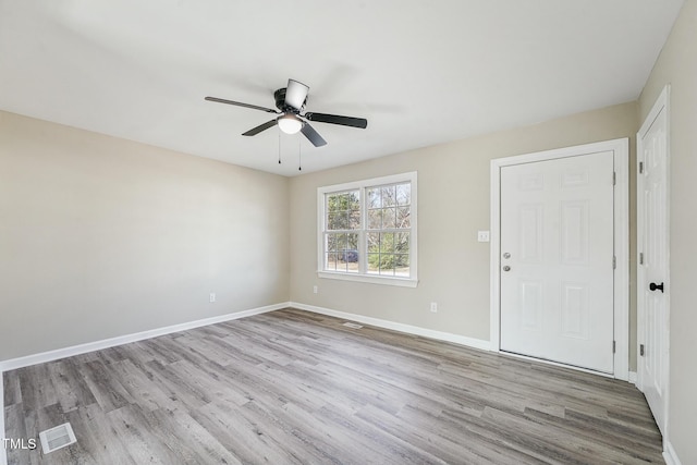 spare room featuring ceiling fan and light hardwood / wood-style floors