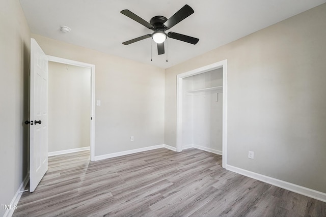 unfurnished bedroom with ceiling fan, a closet, and light hardwood / wood-style floors