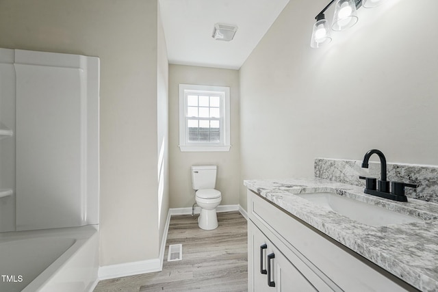 bathroom featuring hardwood / wood-style flooring, vanity, and toilet