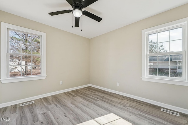 spare room featuring light hardwood / wood-style floors and ceiling fan