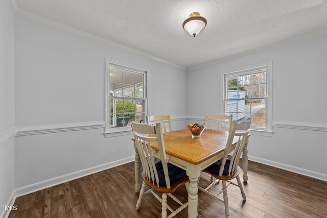 dining area featuring dark hardwood / wood-style flooring, crown molding, plenty of natural light, and a textured ceiling