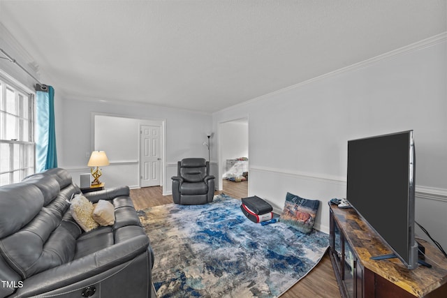 living room with ornamental molding and hardwood / wood-style floors