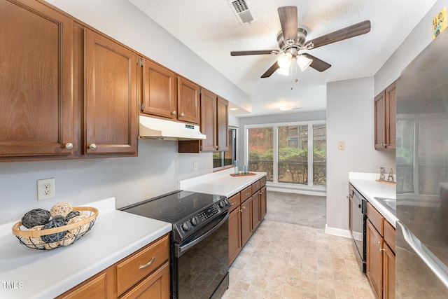 kitchen featuring sink, light colored carpet, ceiling fan, black appliances, and a textured ceiling