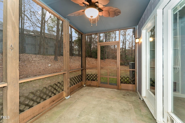 unfurnished sunroom with ceiling fan