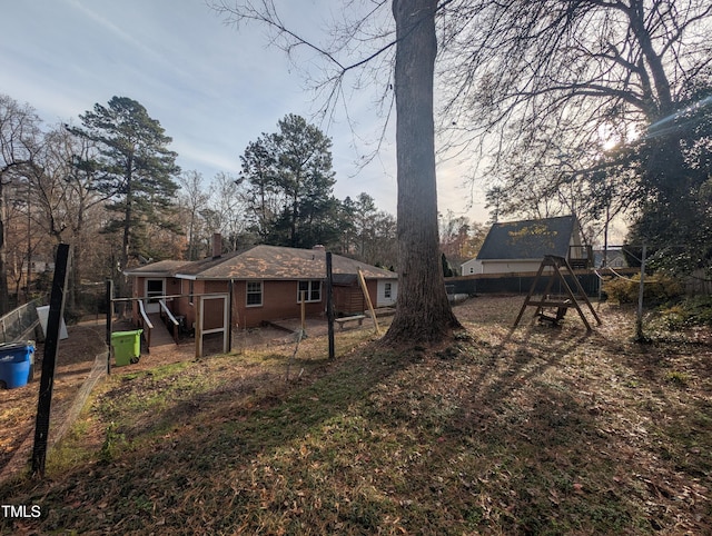 rear view of house with a playground