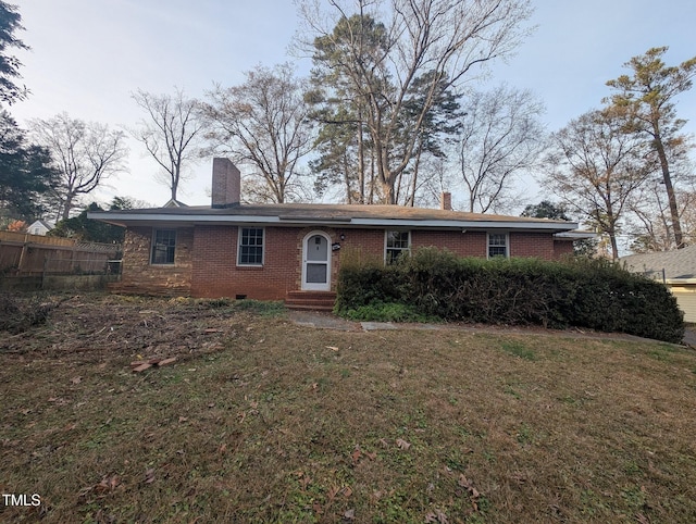 rear view of house featuring a lawn