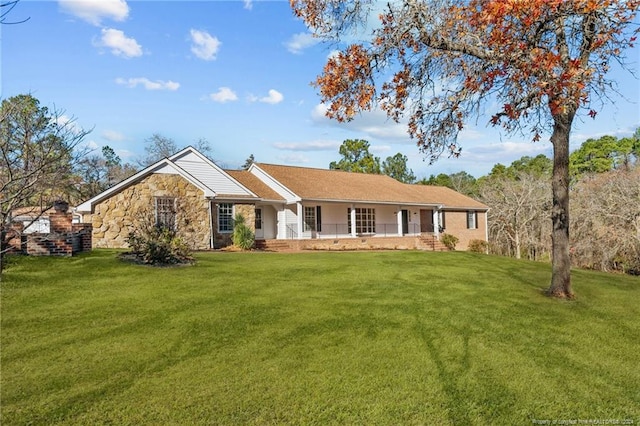 single story home featuring covered porch and a front yard