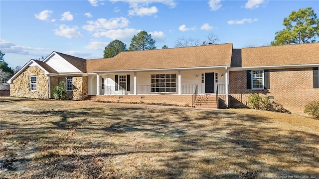 ranch-style home with covered porch and a front lawn