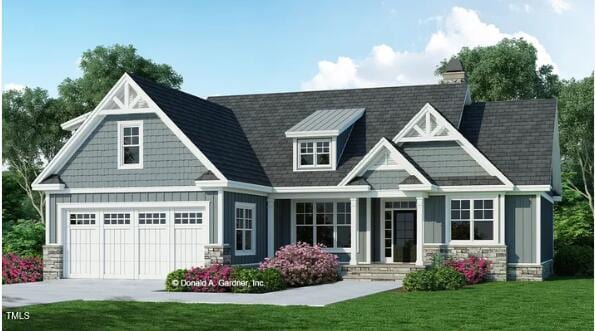 craftsman inspired home with a front yard and a garage