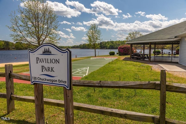 view of property's community with a water view, a gazebo, and a lawn