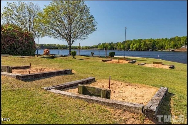 surrounding community with a yard and a water view