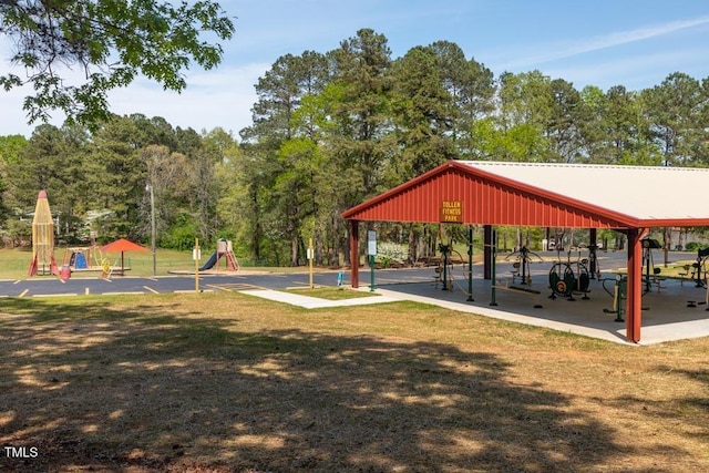 view of home's community featuring a playground and a yard