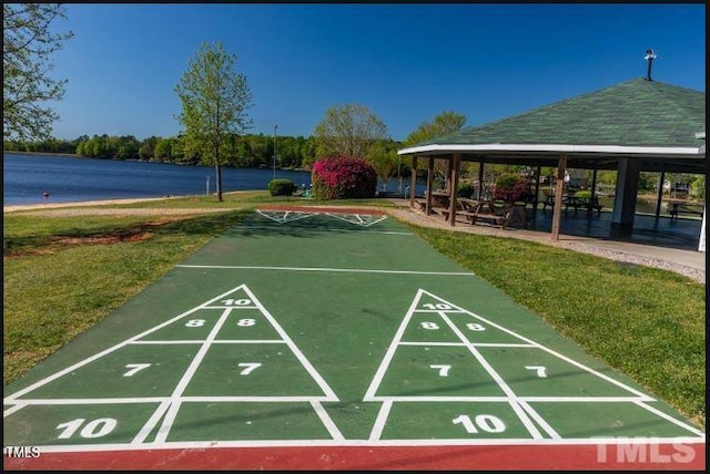 view of property's community featuring a yard, a water view, and a gazebo