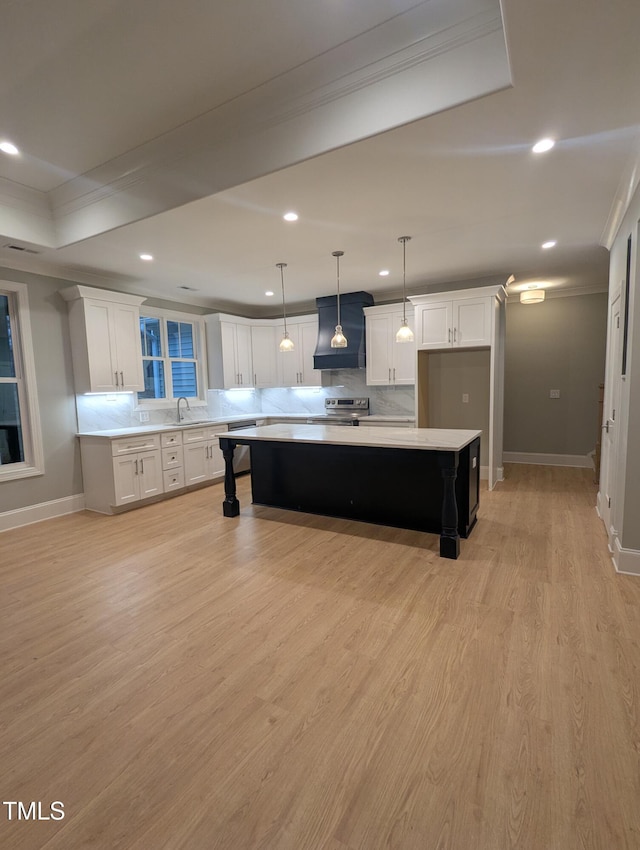 kitchen featuring a center island, white cabinetry, pendant lighting, light wood-type flooring, and electric range