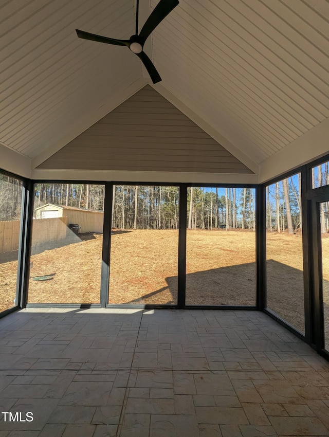 unfurnished sunroom with vaulted ceiling and ceiling fan