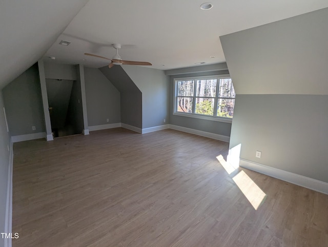 bonus room featuring light wood-type flooring, vaulted ceiling, and ceiling fan